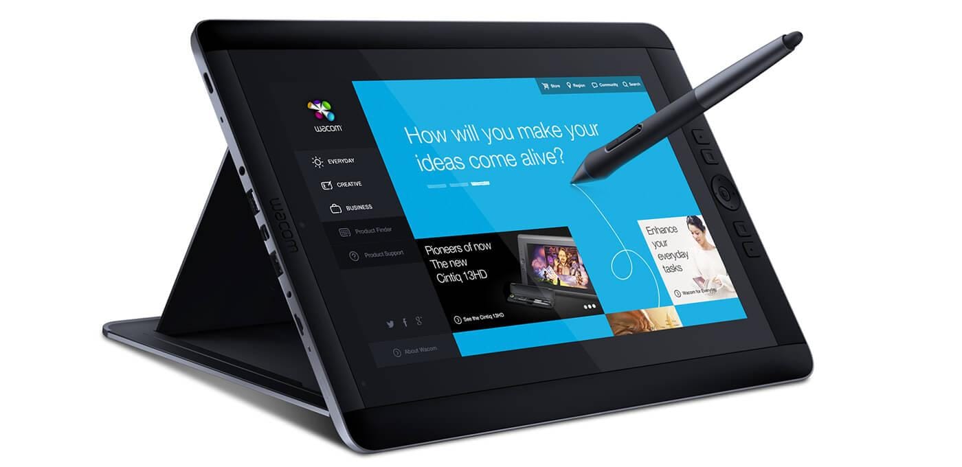Wacom drawing tablet in tent mode with a stylus, showing a blue UI and the text “How will you make your ideas come alive?”