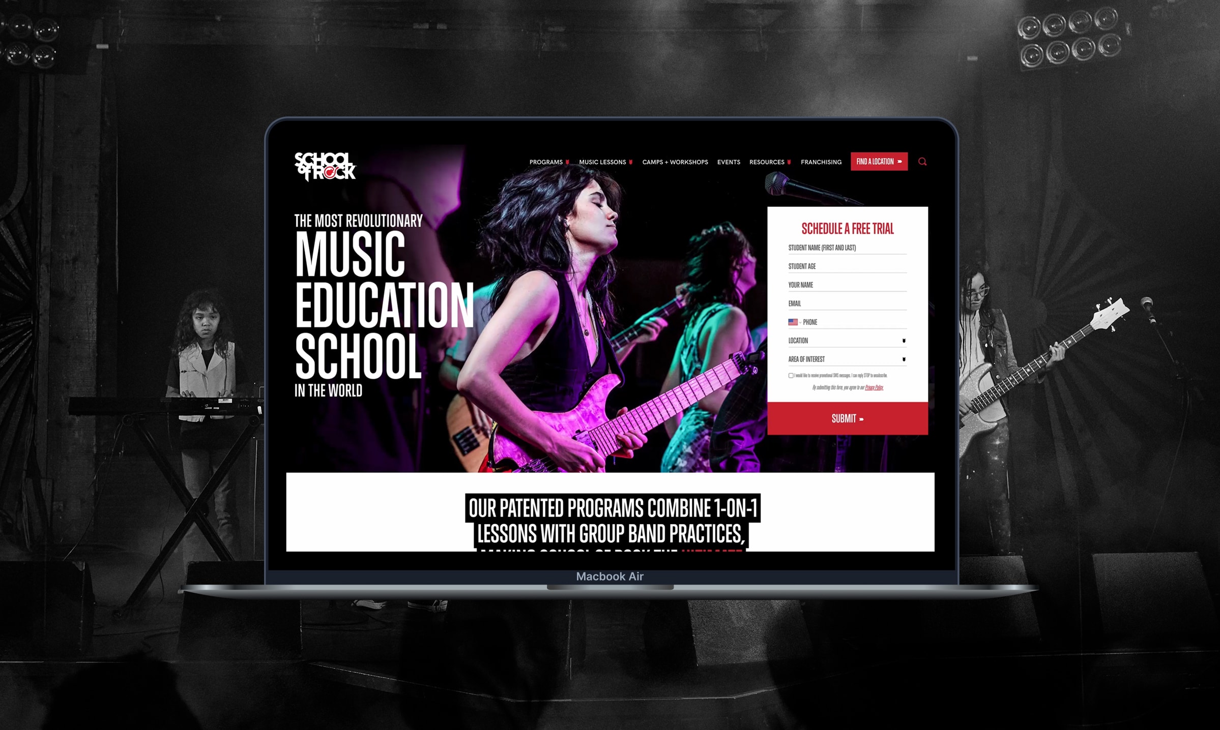 MacBook Air on a dim concert stage displays a colorful School of Rock page with a guitarist, bold Music Education School text, and a free-trial form.