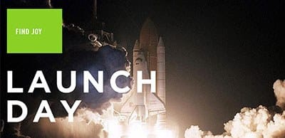 Night rocket launch with bright flame and billowing smoke; bold white LAUNCH DAY text overlays the scene, and a green FIND JOY badge sits in the top-left.