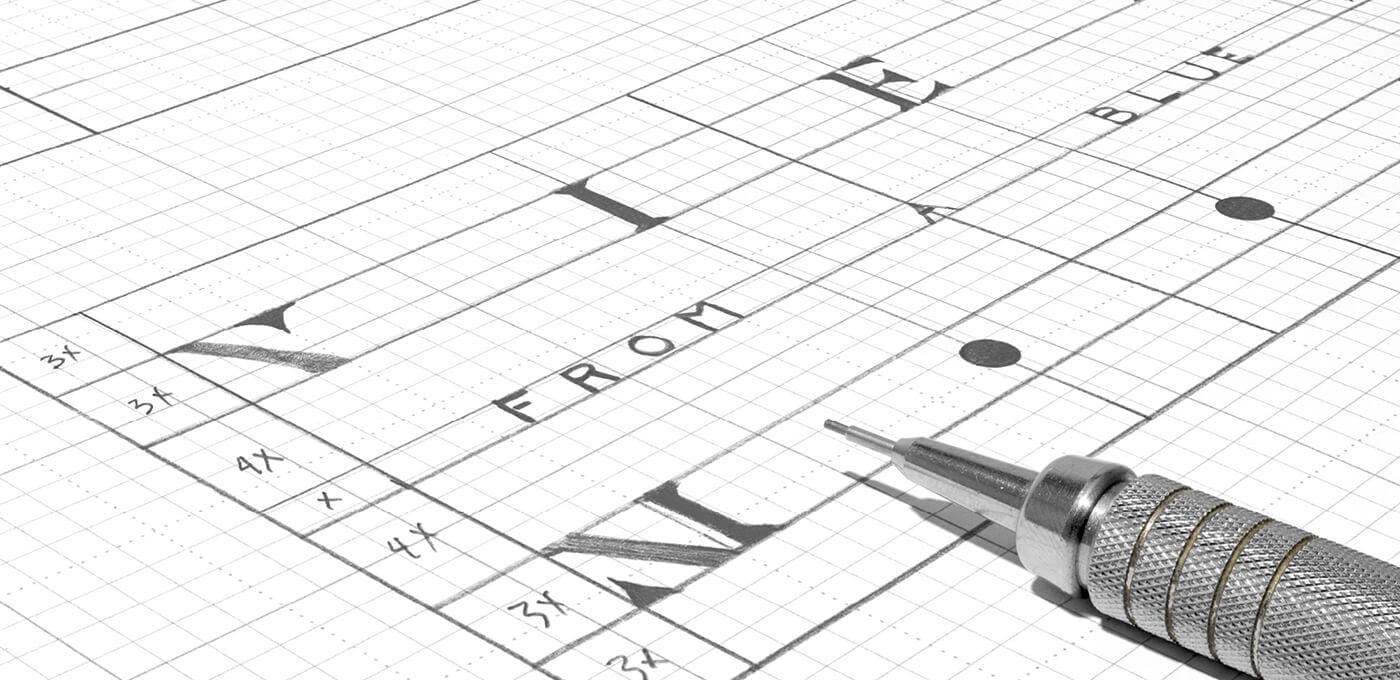 Close-up of a technical drawing on graph paper with ruler lines, measurement marks, and a metal mechanical pencil at the lower right.
