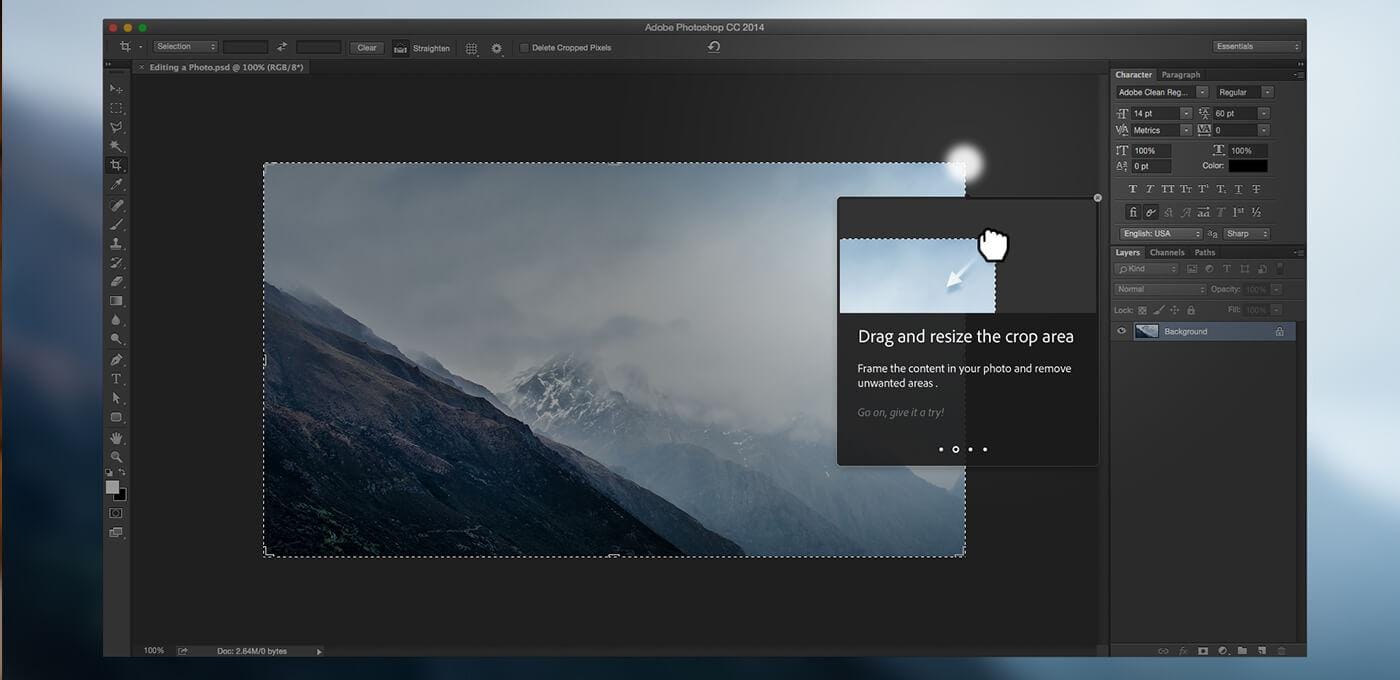 Screenshot of Adobe Photoshop CC 2014: mountain photo with a dashed crop box; a help popup reads Drag and resize the crop area with a cursor.