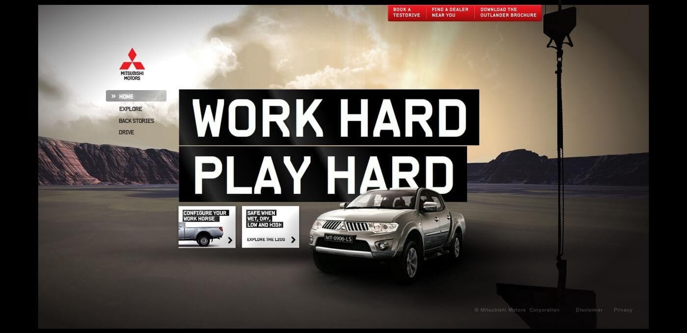Mitsubishi Motors hero banner with a silver pickup in a desert scene, bold "WORK HARD / PLAY HARD" text, left navigation menu, and a tall streetlamp on the right.