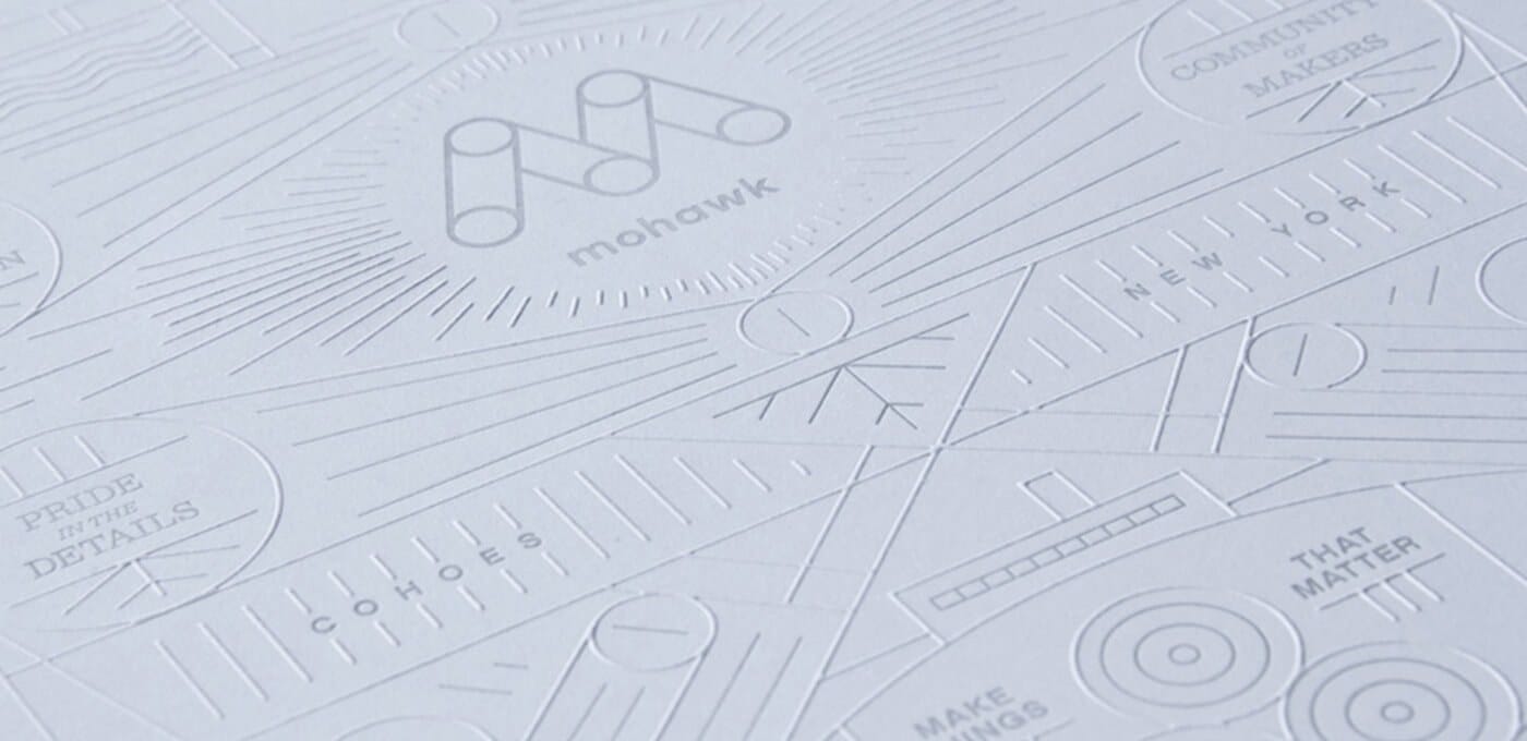 A pale embossed pattern of lines, circles, and slogans including 'Pride in the Details', 'That Matters', 'New York', and a Mohawk logo.