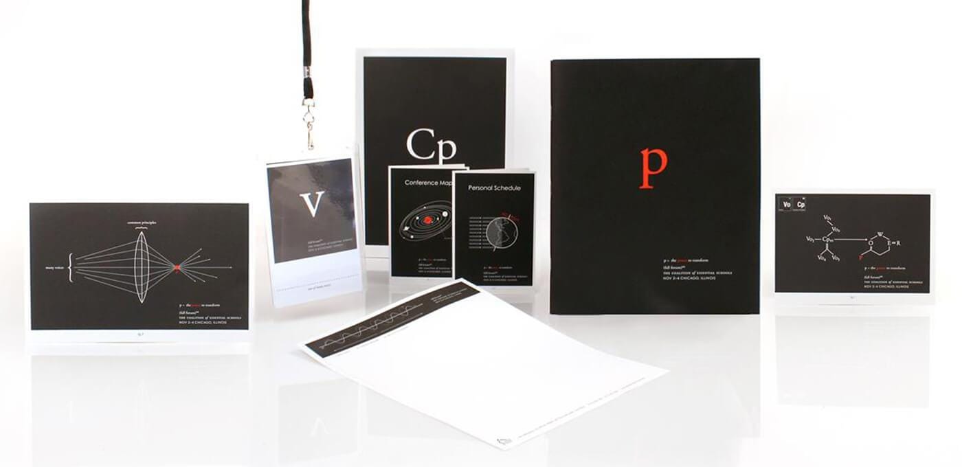 Black cards and posters with white text and red letters (Cp, p) arranged on a white surface, featuring diagrams, a lanyard badge, and a white sheet.