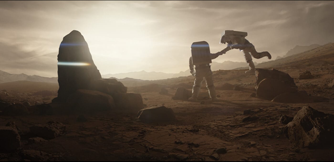 Two astronauts in spacesuits on a dusty alien landscape at sunrise, near a large rock monument; one reaches out to help the other climb.