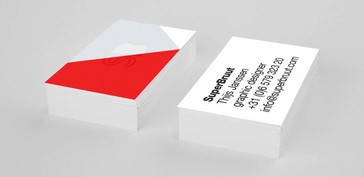 Two stacks of white business cards on a light gray surface; left stack has a bold red block, right stack shows black text with a name and contact.